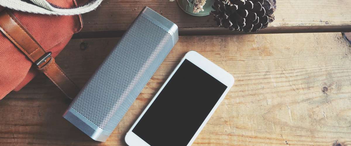 portable bluetooth speaker next to a smartphone