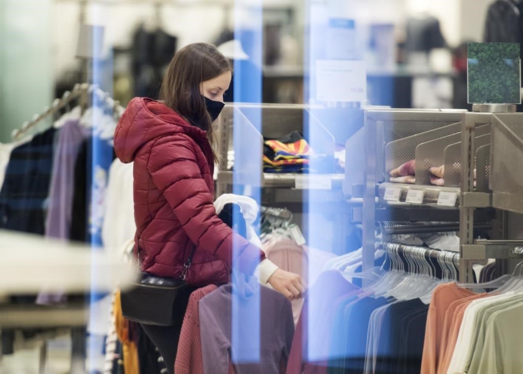 Statistics Canada will release its latest reading for inflation on Tuesday when it publishes its consumer price index for July. A woman shops in a clothing store in Montreal, Sunday, November