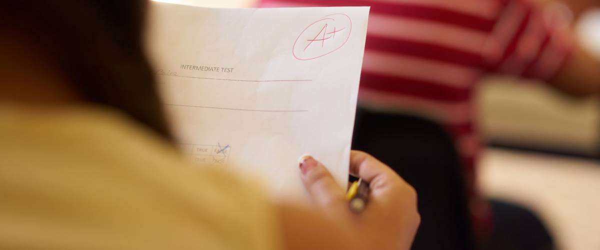 Teenager reviewing her A+ test in class.