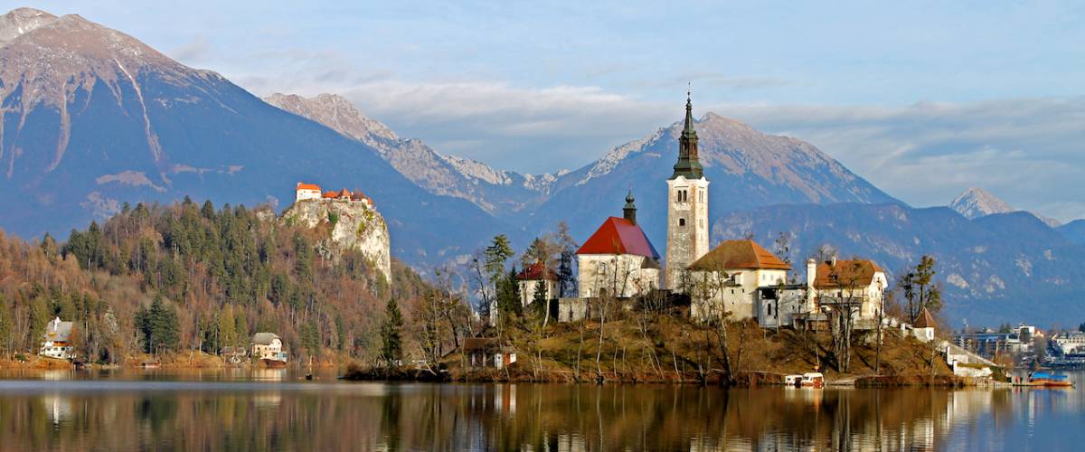Blejski Otok, Lake Bled, Slovenia, featuring the church, lake, reflections, mountains.