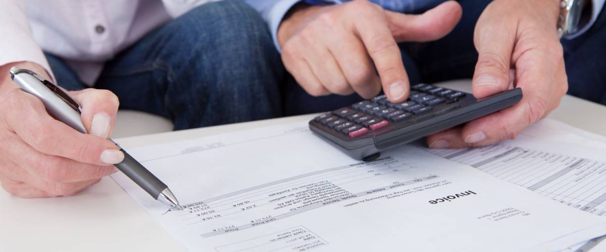 Close-up of mature couple doing finances at home