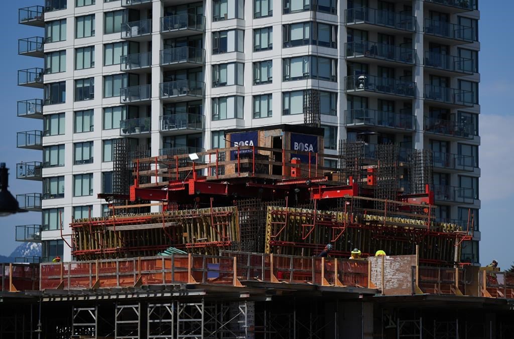 Workers are seen on a condo tower under construction in Coquitlam, B.C., on Tuesday, May 16, 2023. British Columbia&#039;s construction industry says its workforce numbers have improved in recent 