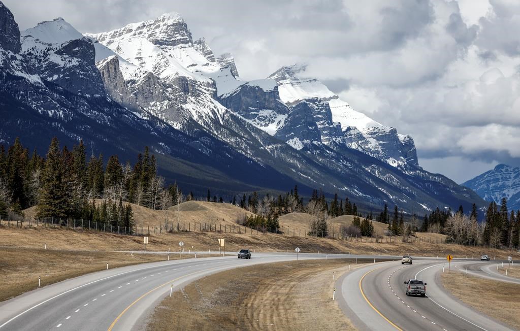 Traffic travels along the Trans Canada Highway past Mount Rundle of the Rocky Mountains near Canmore, Alta., Monday, April 24, 2023. Documents released under Alberta Freedom of Information la