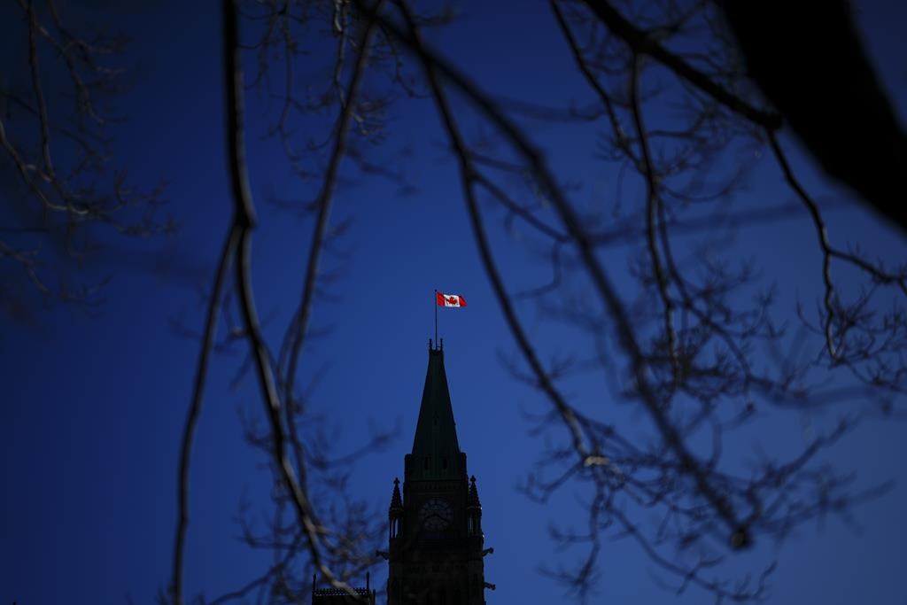 The Canada flag catches the morning light on the Peace Tower on Parliament Hill in Ottawa on Tuesday, April 16, 2024. 