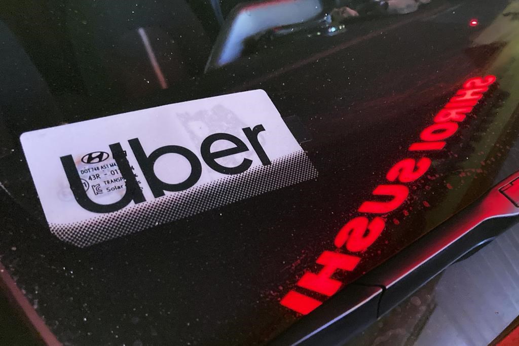An Uber sign is displayed inside a car in Glenview, Ill., Saturday, Dec. 17, 2022. Uber Technologies Inc. says it has brought its ridesharing platform to Newfoundland and Labrador. 