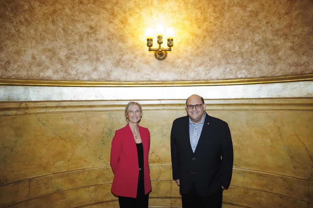 Theatre producer Michael Rubinoff poses alongside Tim Hortons executive Hope Bagozzi at the Elgin Theatre in Toronto, Tuesday, April 9, 2024. Tim Hortons is set to take centre stage with a ne