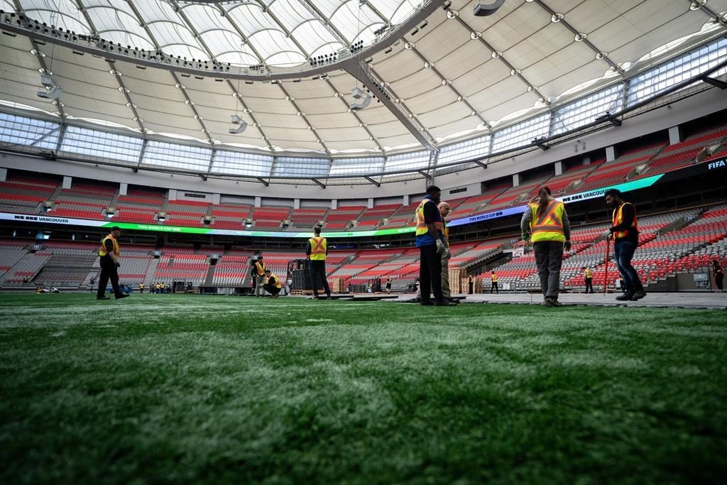 Crews work on the turf at B.C. Place during a FIFA World Cup 2026 update in Vancouver, Tuesday, April 30, 2024. 