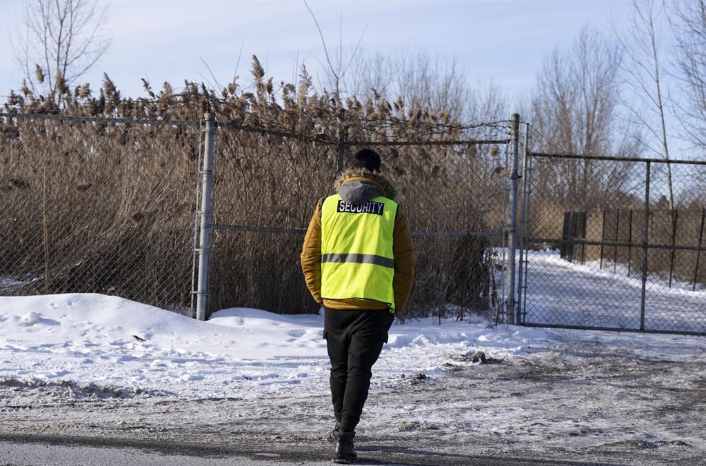 Security guards the entrance to the construction site of the new EV battery plant, Northvolt, in Saint-Basile-le-Grand, east of Montreal, Quebec, Friday, Jan. 19, 2024. The company behind the