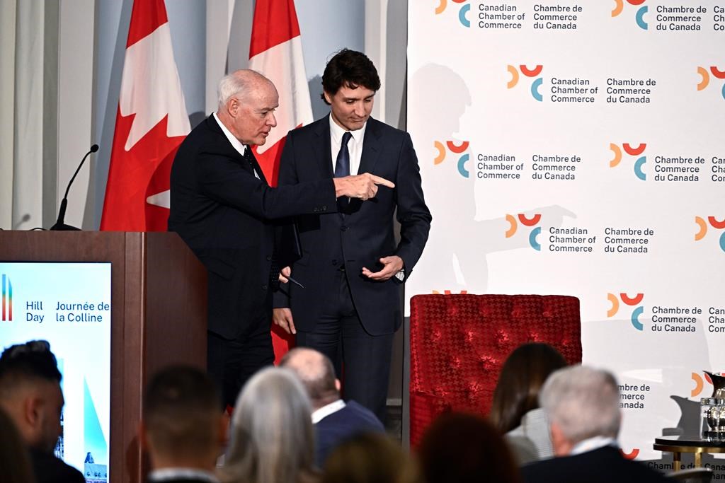 Perrin Beatty, president of the Canadian Chamber of Commerce, points Prime Minister Justin Trudeau to his seat for a fireside discussion, after Trudeau&#039;s remarks at the Canadian Chamber of Co