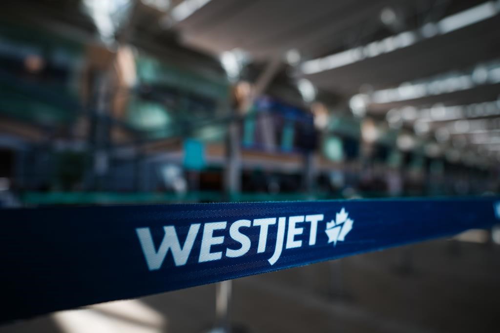 A WestJet logo is seen in the domestic check-in area at Vancouver International Airport, in Richmond, B.C., on Friday, May 19, 2023. The union representing WestJet Encore pilots says its memb