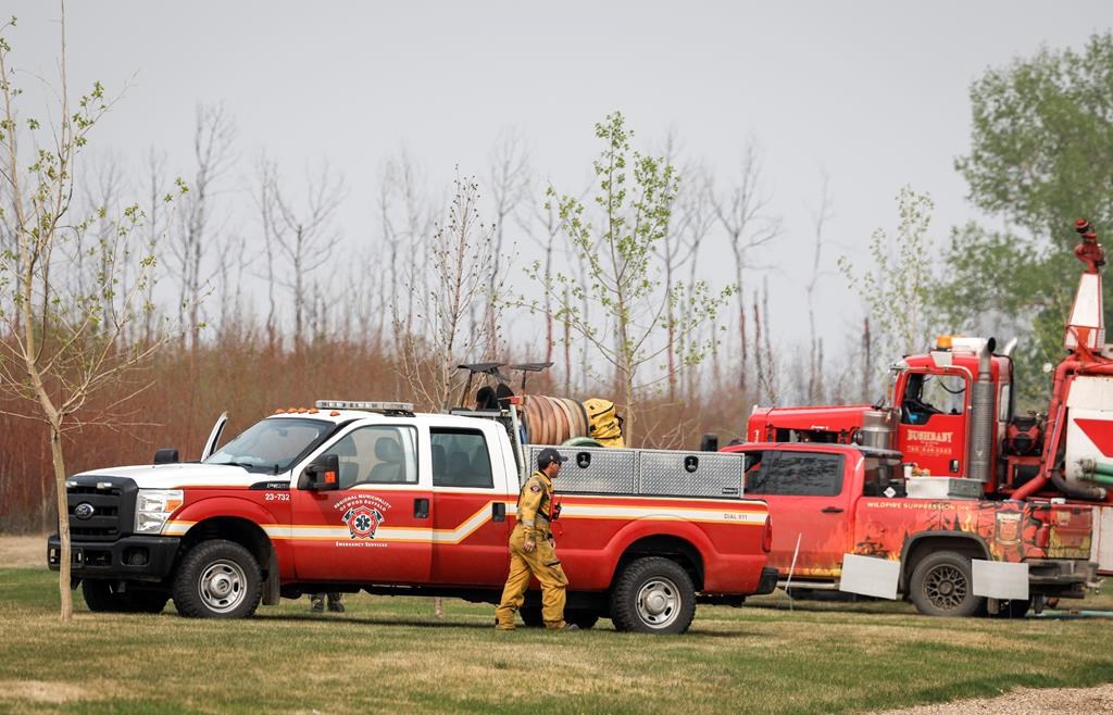Fire-fighting personnel arrive in the evacuated neighbourhood of Beacon Hill in Fort McMurray, Alta., on Wednesday, May 15, 2024. 