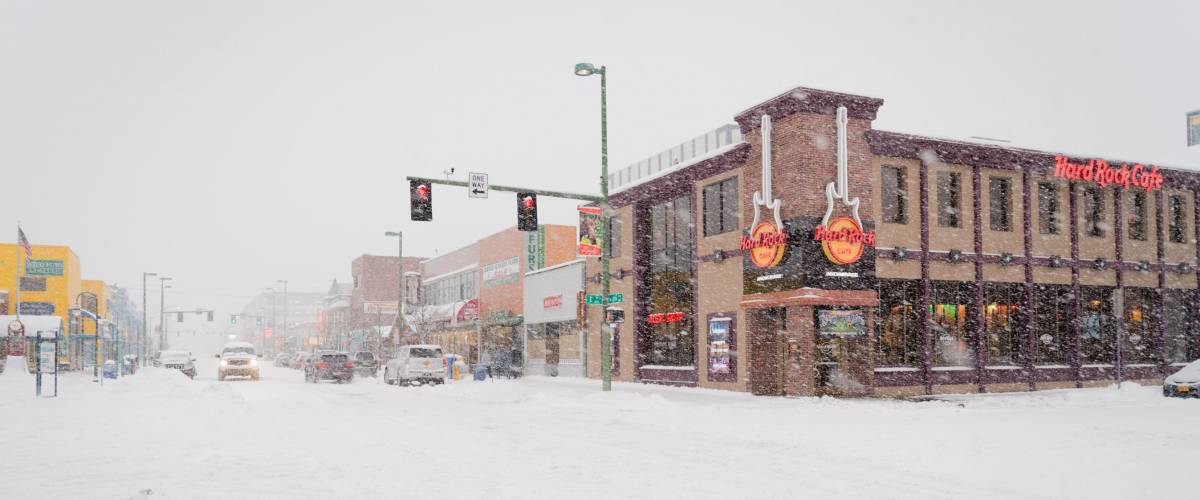 ANCHORAGE, ALASKA - NOVEMBER 21ST: Heavy snowfall and a covered in snow street on a winter day with Hard Rock Cafe on November 21st, 2015 in Anchorage, Alaska