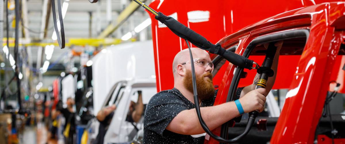 Justin Mound installs an airbag on the assembly line at GM's Chevrolet Silverado and GMC Sierra pickup truck plant in Fort Wayne, Indiana, U.S., July 25, 2018.