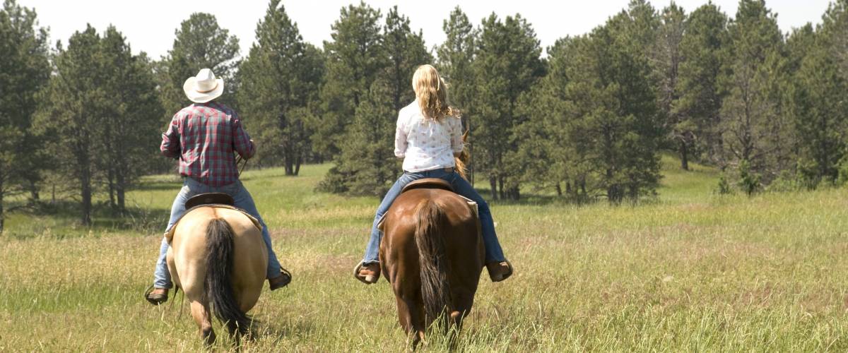 Two People Riding on Wyoming Landscape.