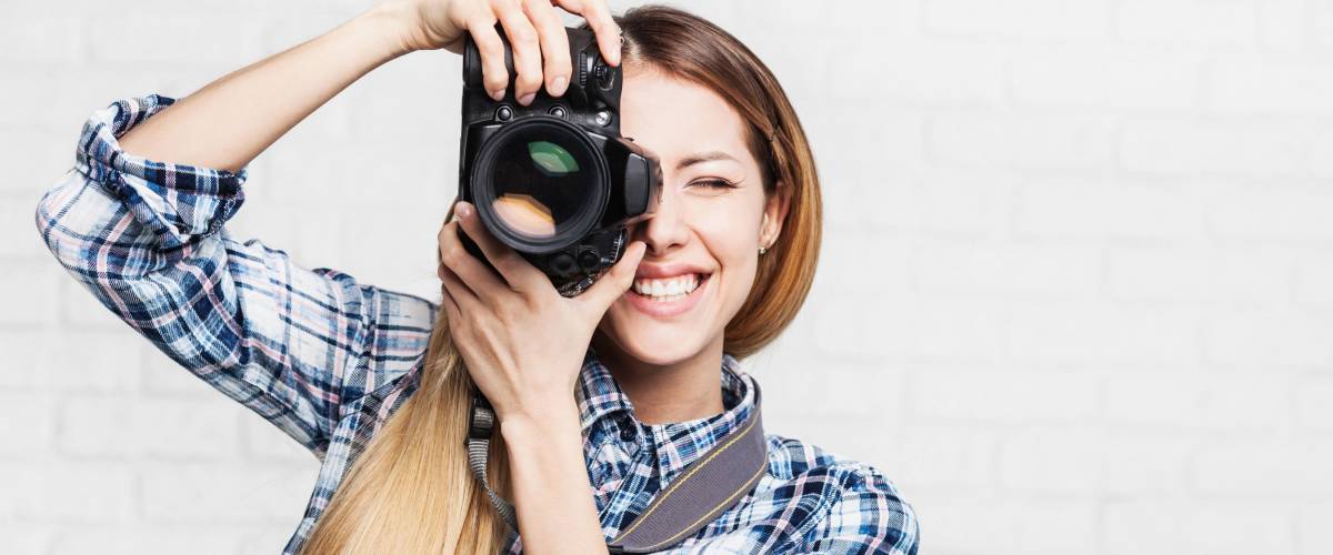 Woman photographer takes images with dslr camera