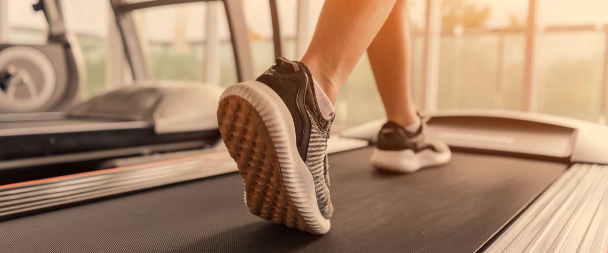 close up of woman's feet running on a treadmill