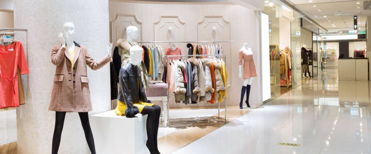 Boutique display window with mannequins in fashionable dresses