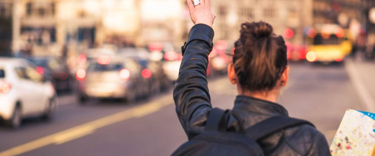 Woman tourist in a foreign city trying to hail a cab