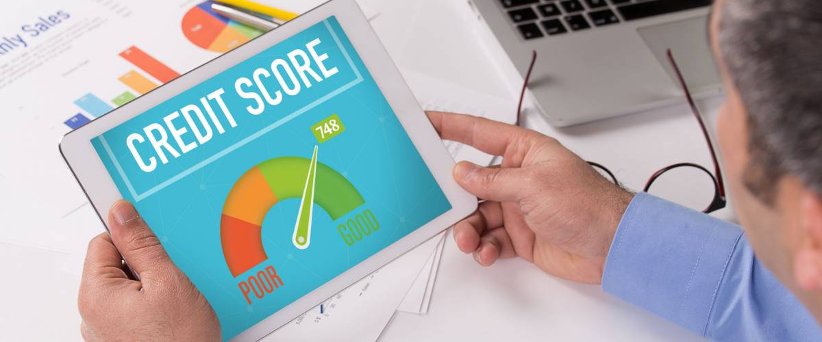 Man working on tablet with CREDIT SCORE on a screen