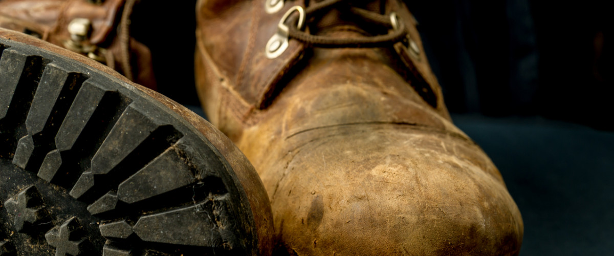 Brown leather work boots on a black background