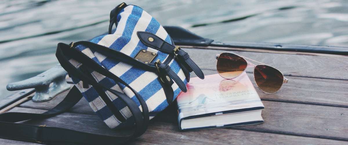 Purse with book and sunglasses