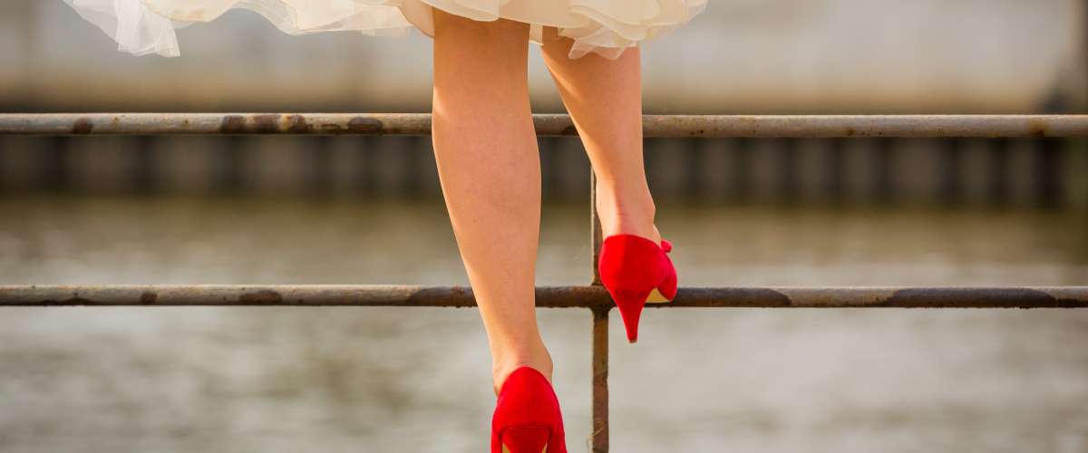 woman in white dress walking in red high heels