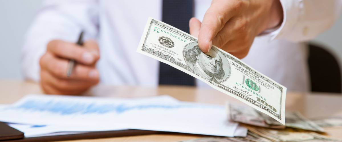 Businessman proposing money to you - closeup shot