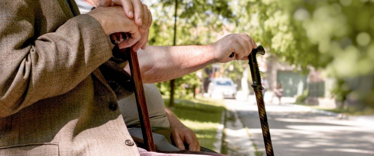 Concept of a retirement age - pensioners, friends sitting in the park and resting