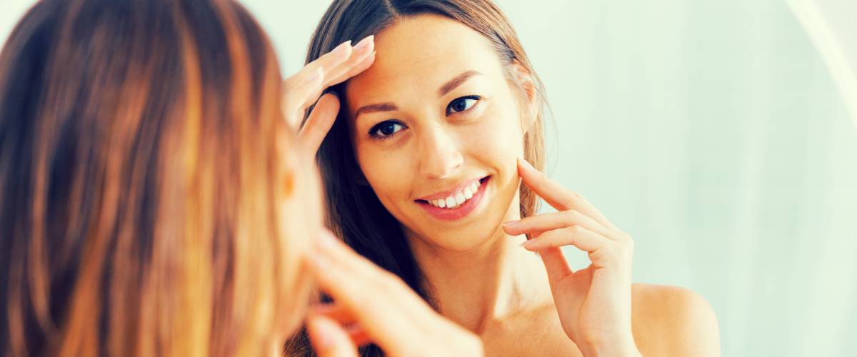 Woman admiring her smile in a mirror