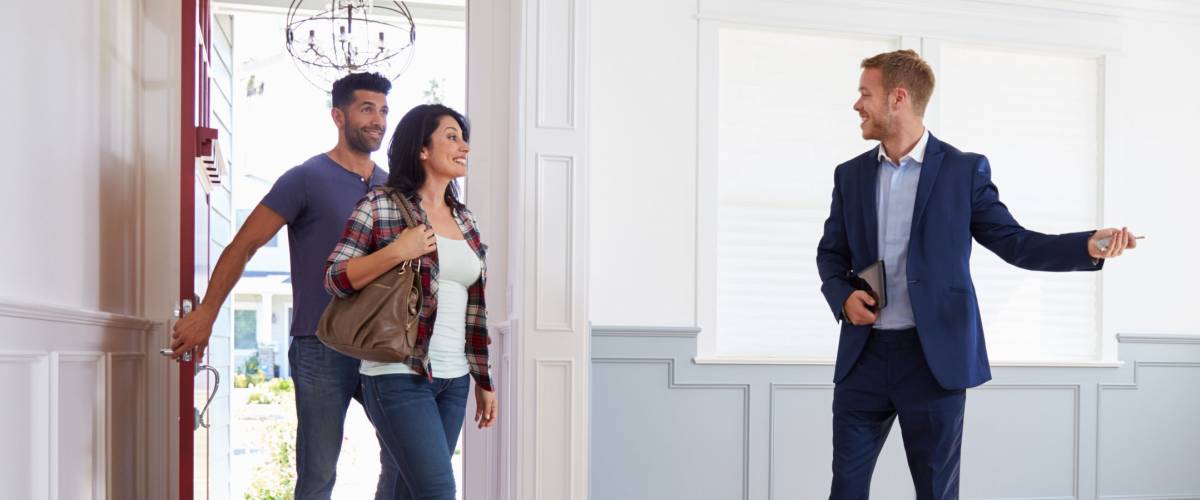 Realtor Showing Hispanic Couple Around New Home