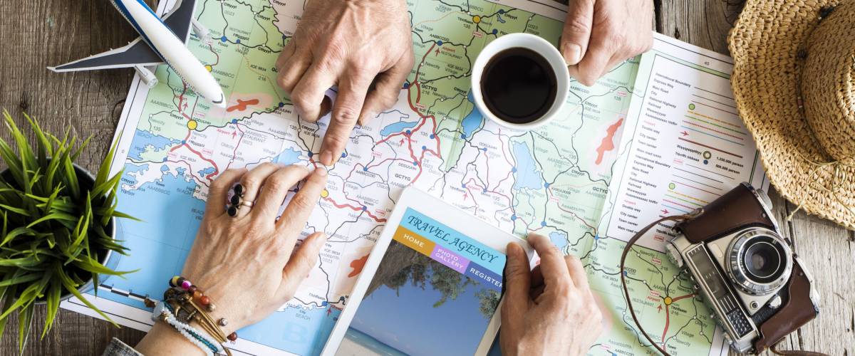 Two people planning to travel over a map