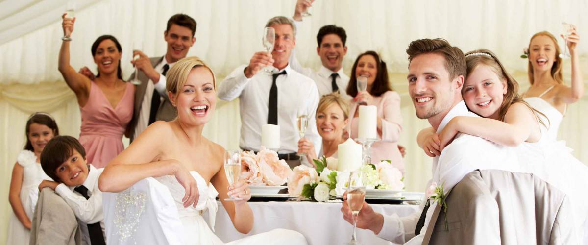 Bride And Groom Celebrating With Guests At Reception