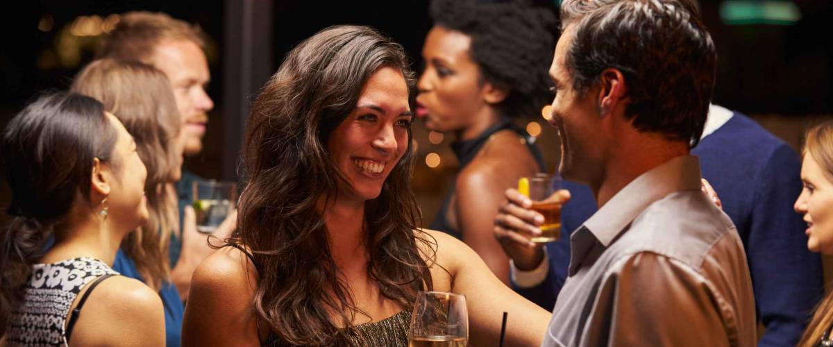 Couples Dancing And Drinking At Evening Party