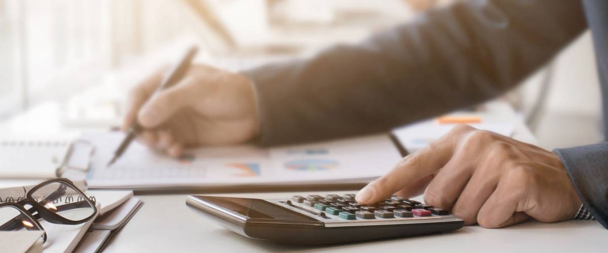 Businessman working with calculator and document data