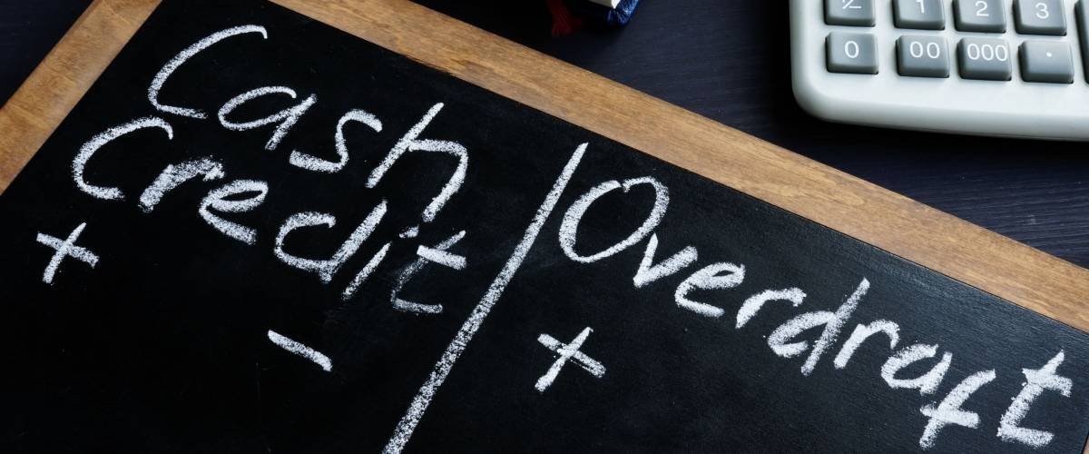 Cash Credit vs Overdraft handwritten on a blackboard.