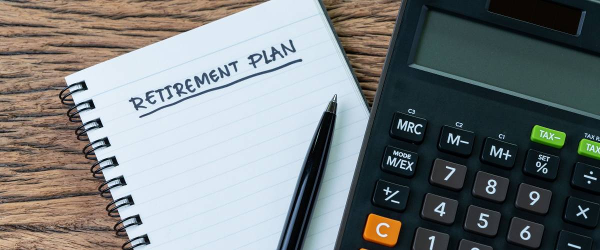 Retirement planning concept, calculator with empty notepad with pen