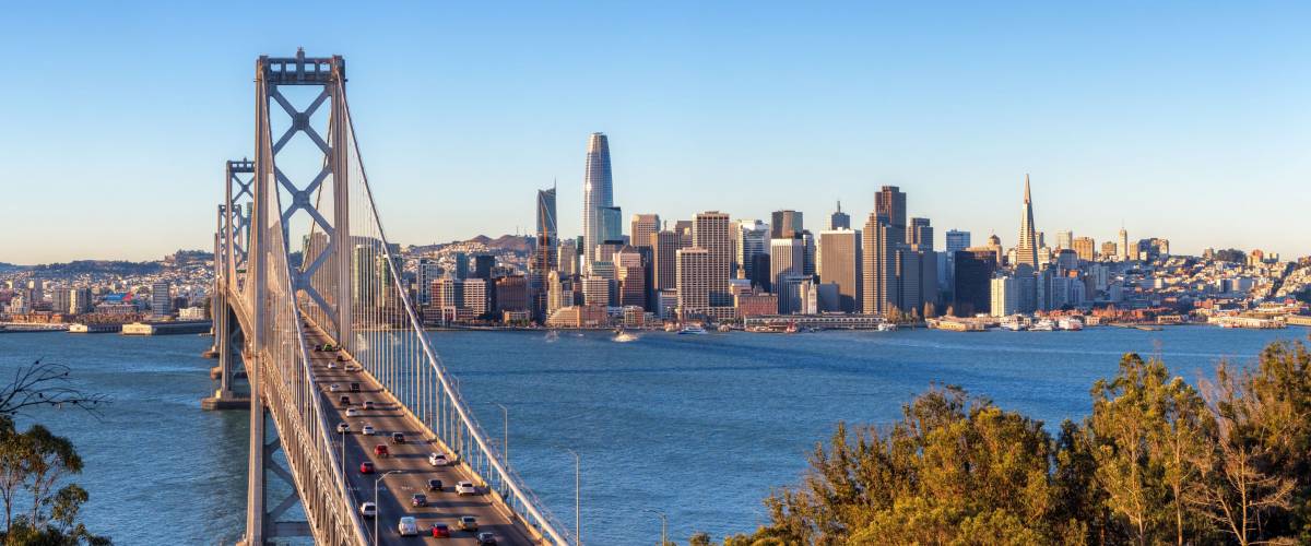 San Francisco skyline and Bay Bridge at sunrise, California
