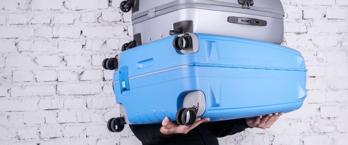 Man lifting suitcases for exercise