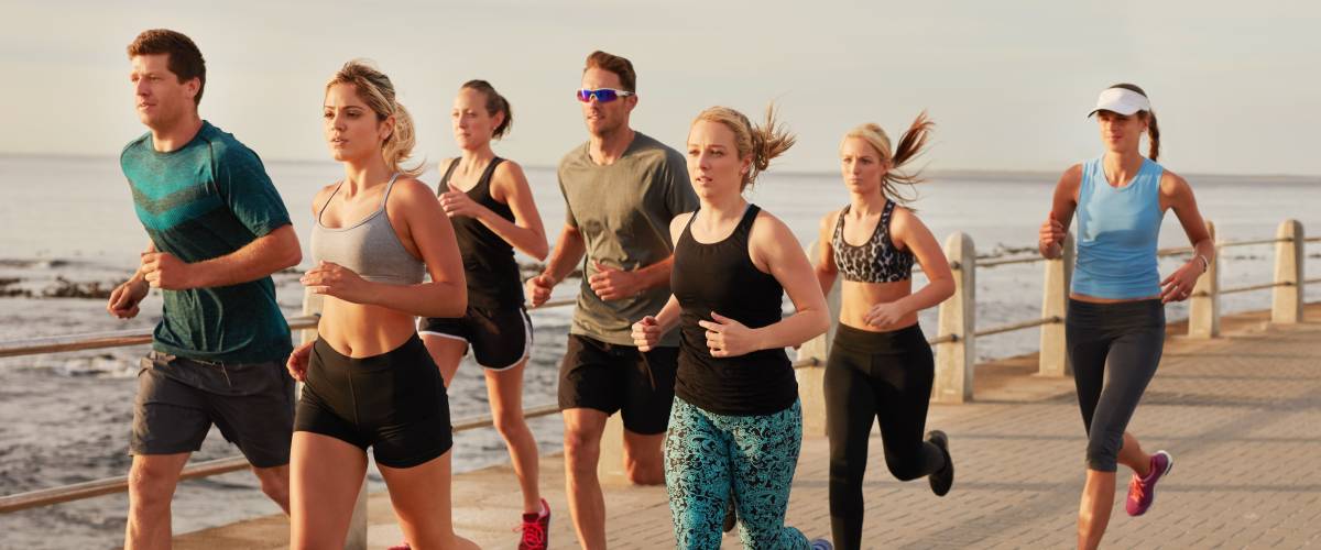 Members of a running club jogging on a boardwalk