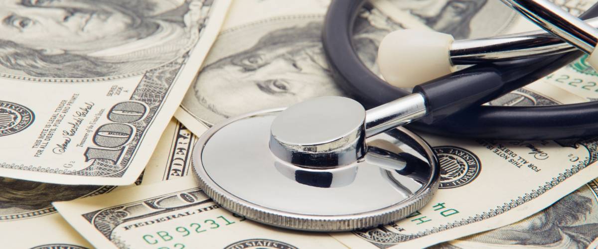 heap of dollars with stethoscope