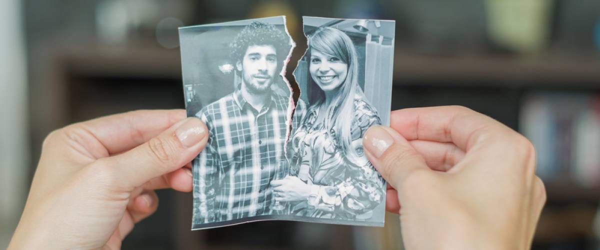 hands pulling apart photo of happy couple