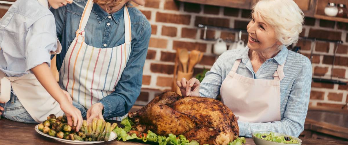 beautiful women of three generations preparing dishes for thanksgiving dinner