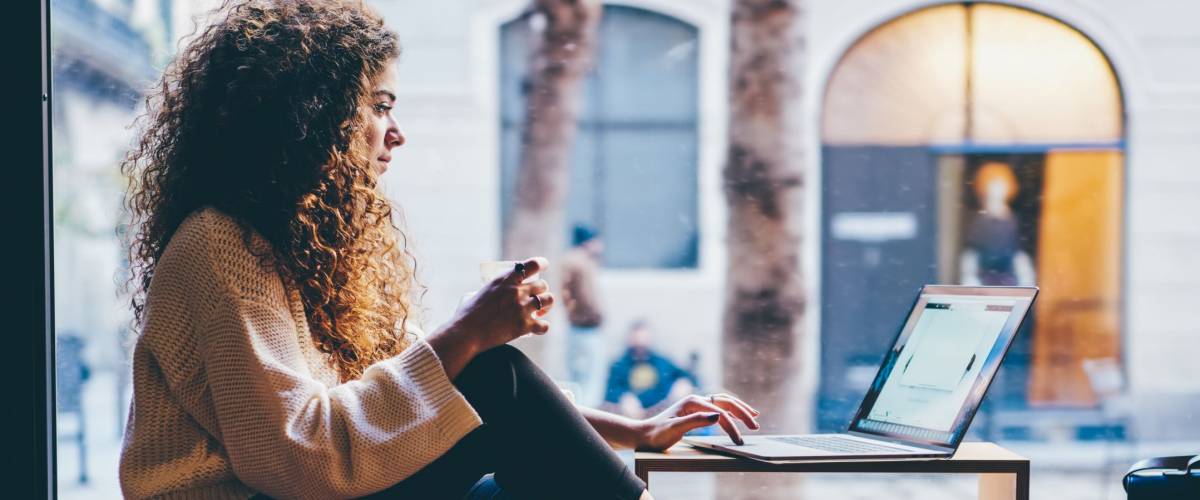 Young pondering woman opening a bank account online