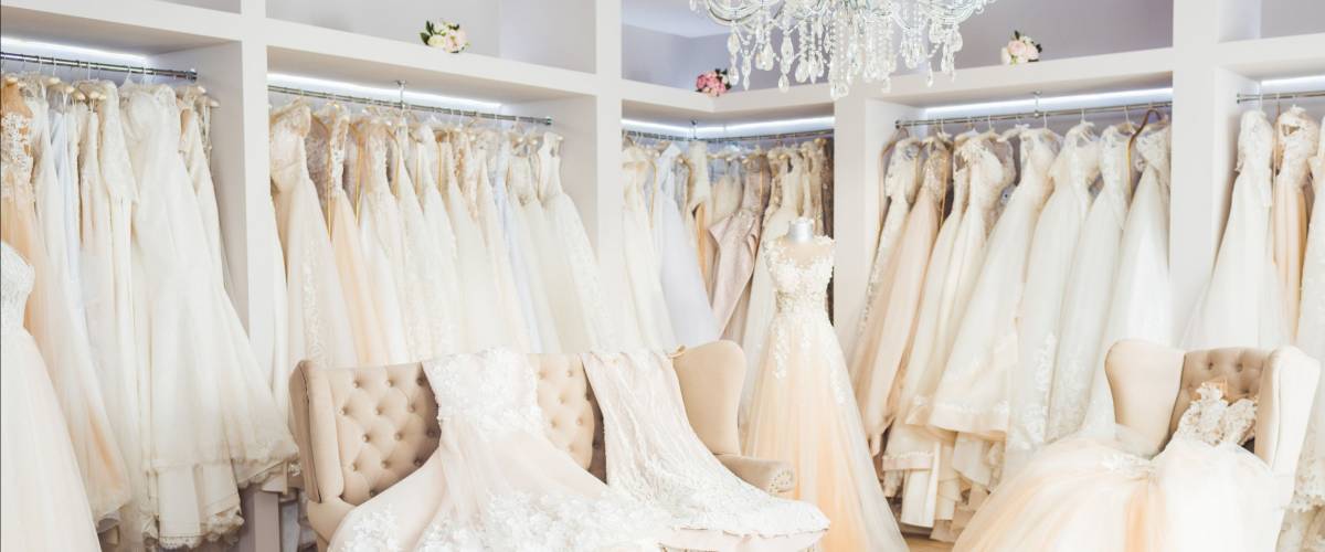 Beautiful wedding dresses on hangers in wedding atelier