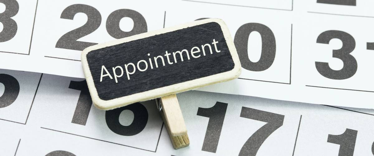 Appointment reminder on calender and chalkboard - Business Concept.