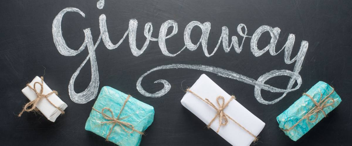 Inscription Giveaway written on the board with gifts