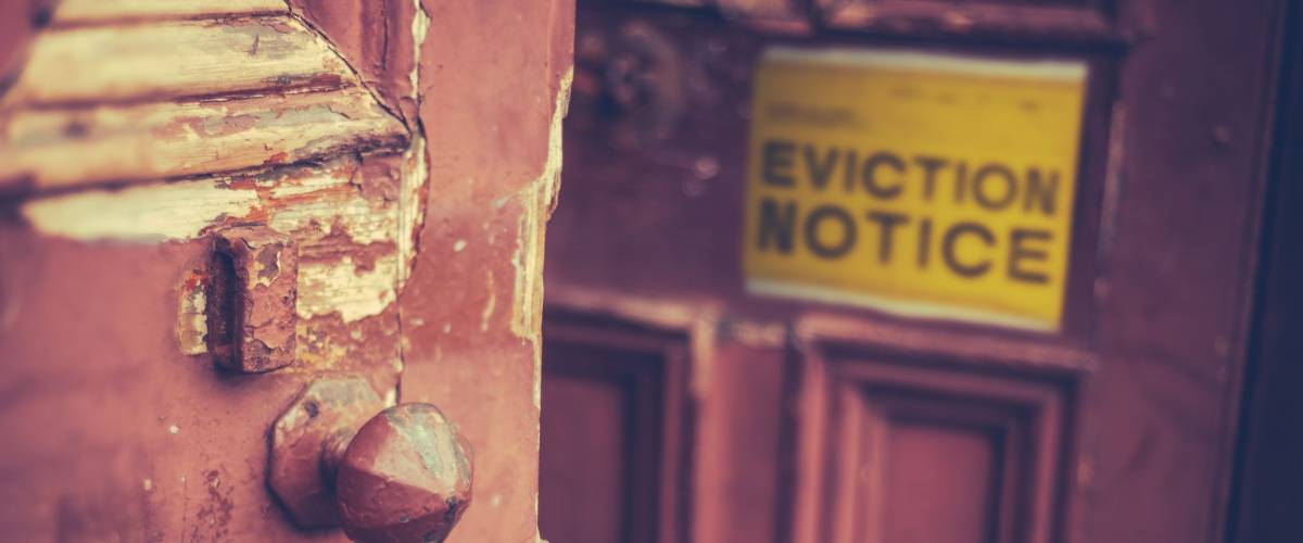Grungy Old Door With A Yellow Eviction Notice