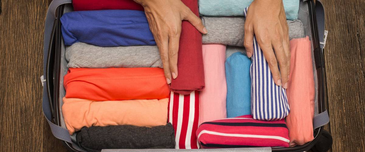 woman packing a luggage for a new journey