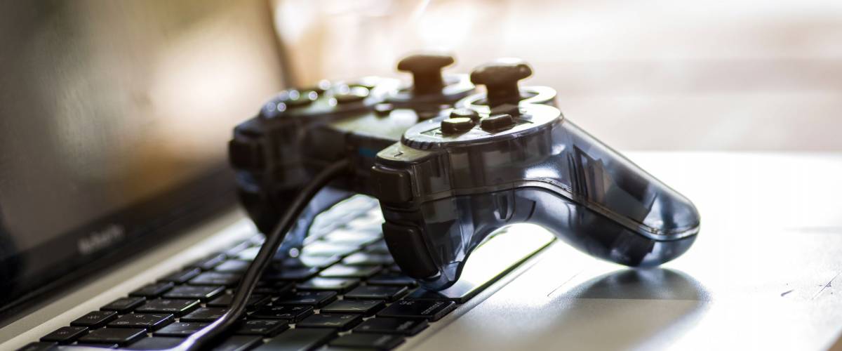 Video game controller isolated on the laptop.