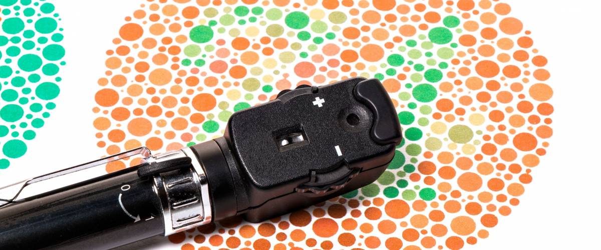 Ophthalmoscope is on a Ishihara color vision test chart